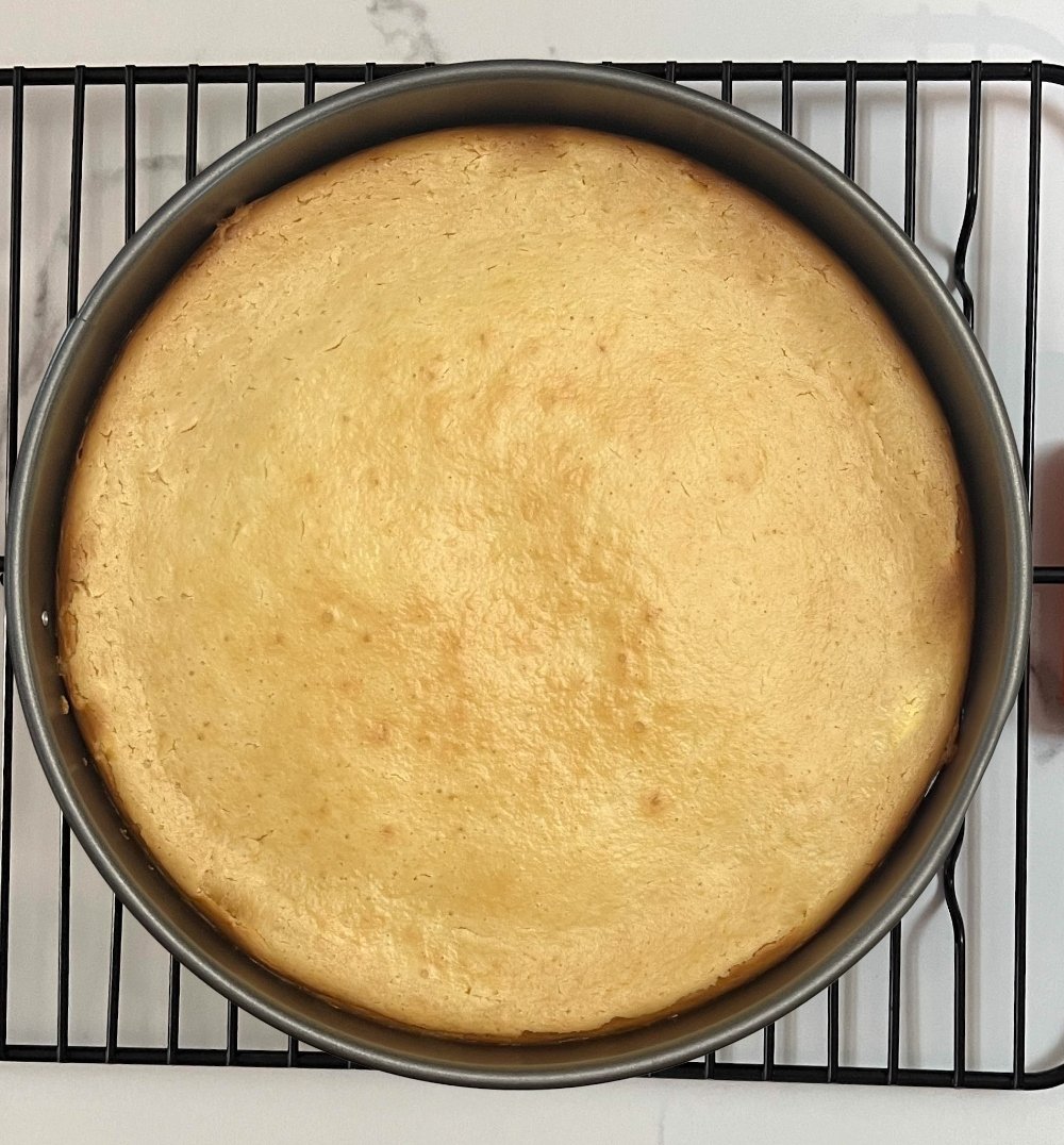 cheesecake cooling on a wire rack