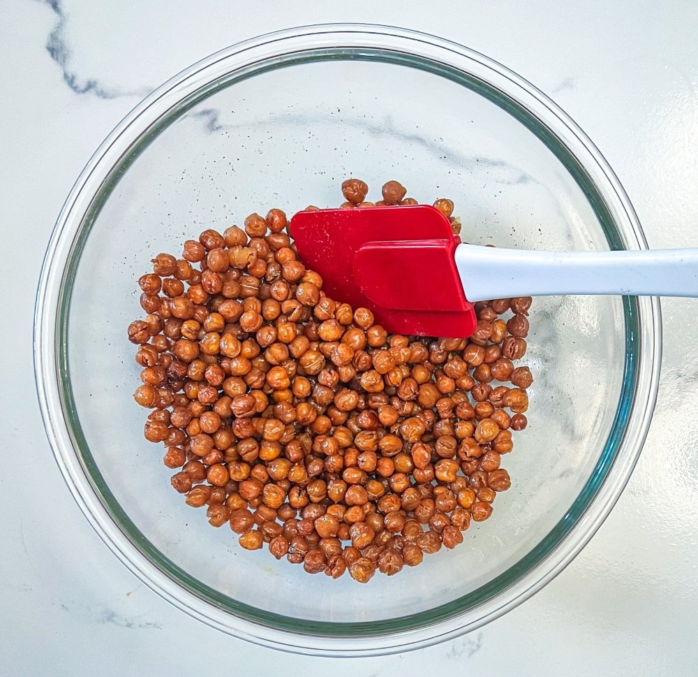 mixing crispy chickpeas with seasoning