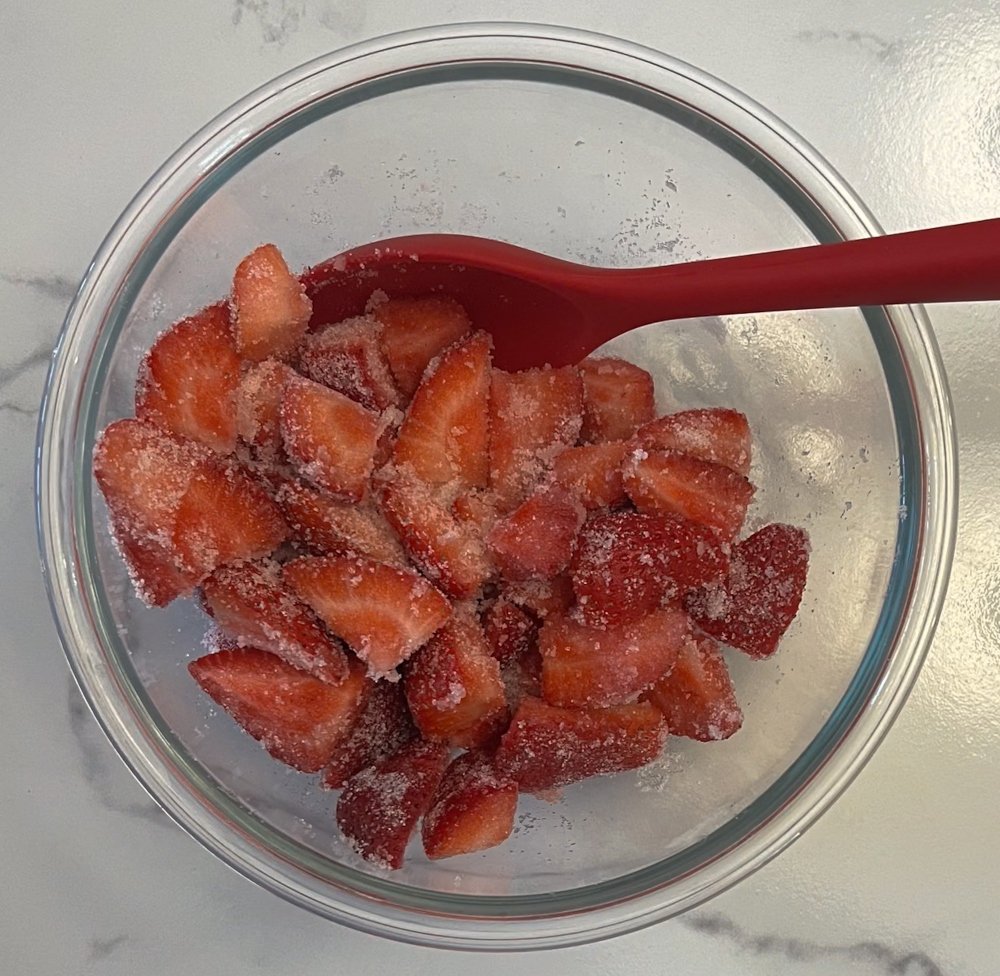 Mixing strawberries and sugar