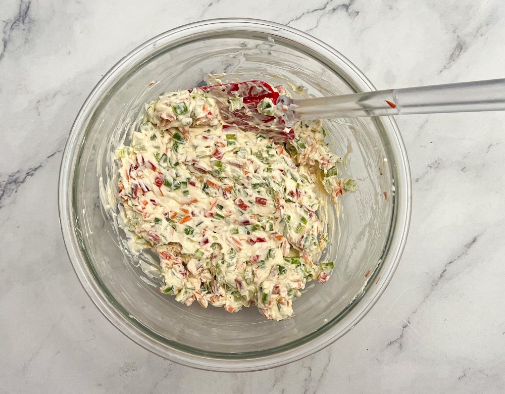 Mixing veggies with cream cheese