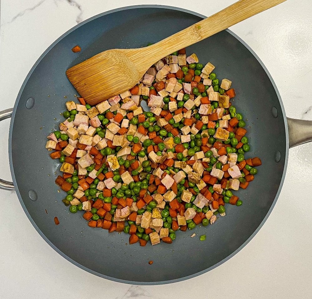 Pork, peas, and carrots in wok