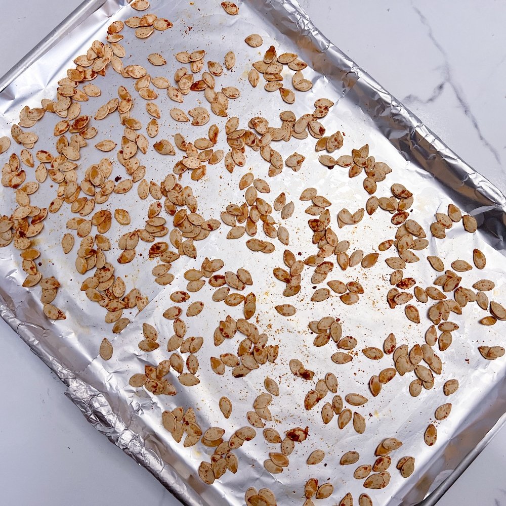 Smoked pumpkin seeds on baking sheet