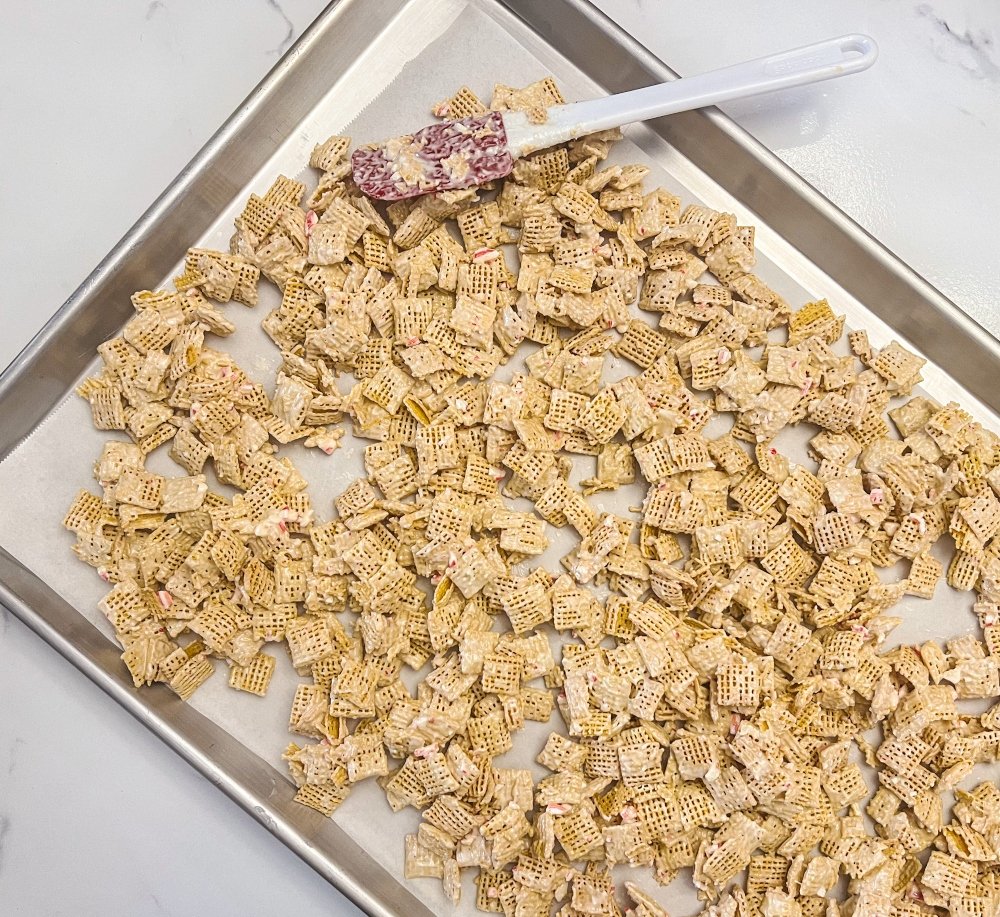 Spreading candy cane crunch on the baking sheet