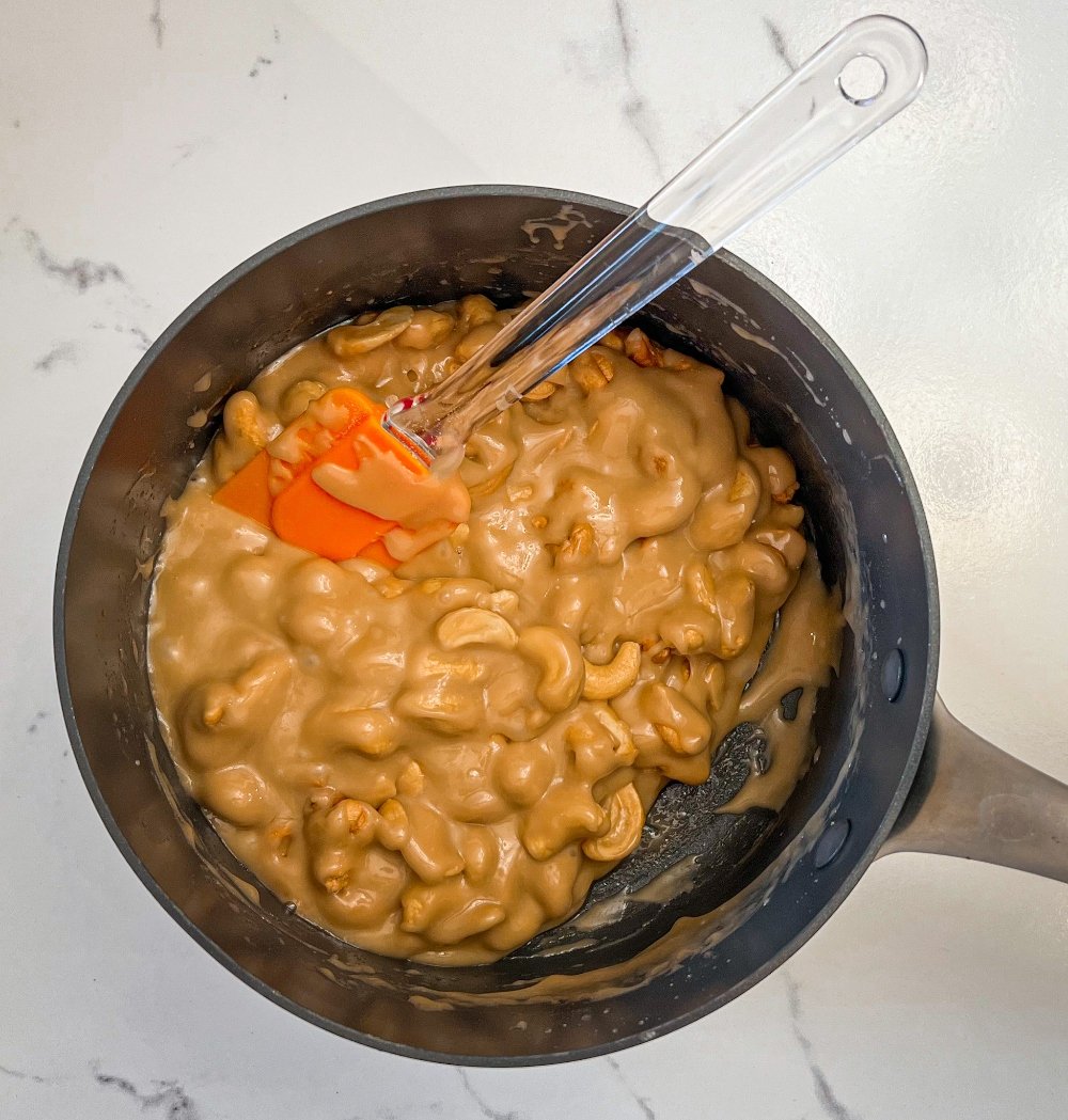 stirring in cashews to sugar mixture