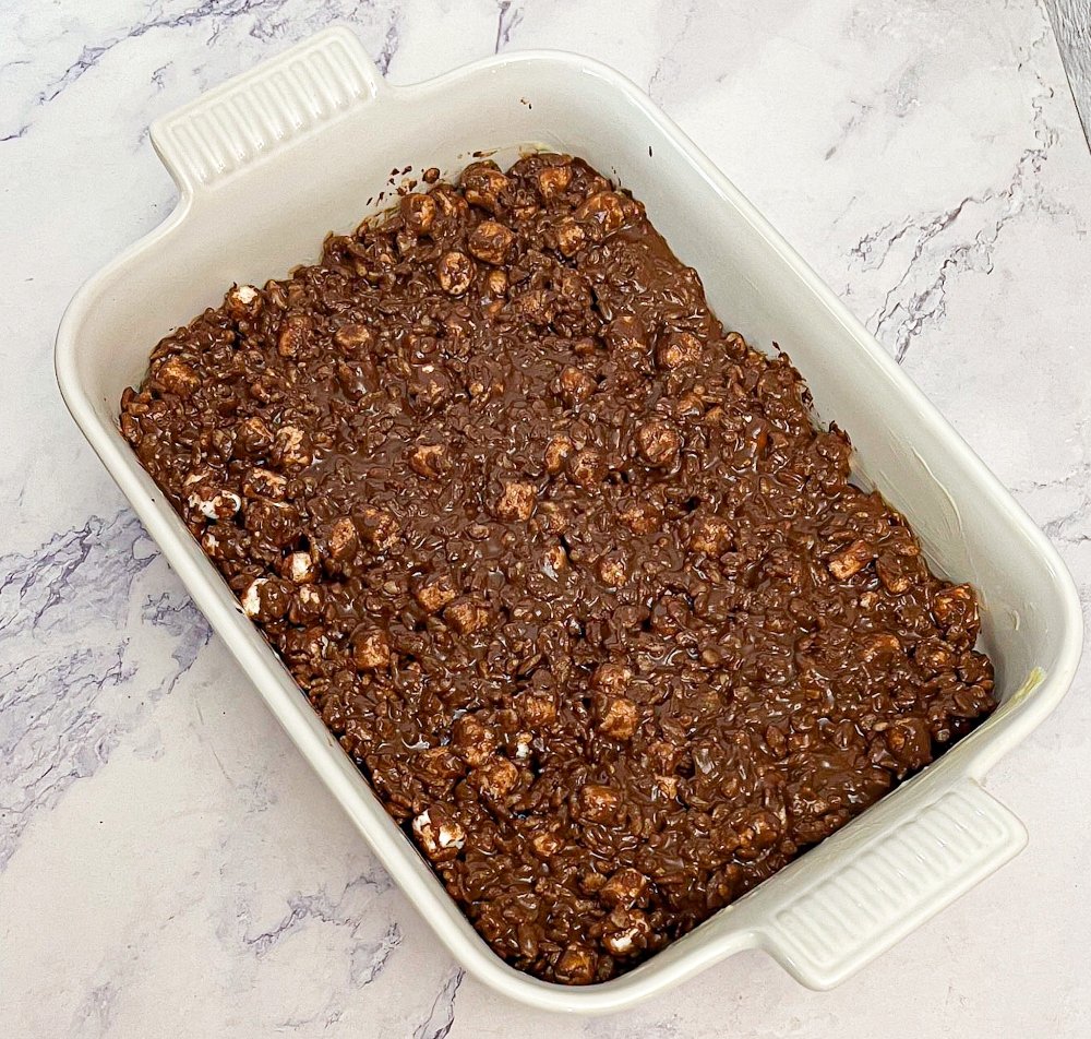 Pressing Rocky Road bars into baking dish