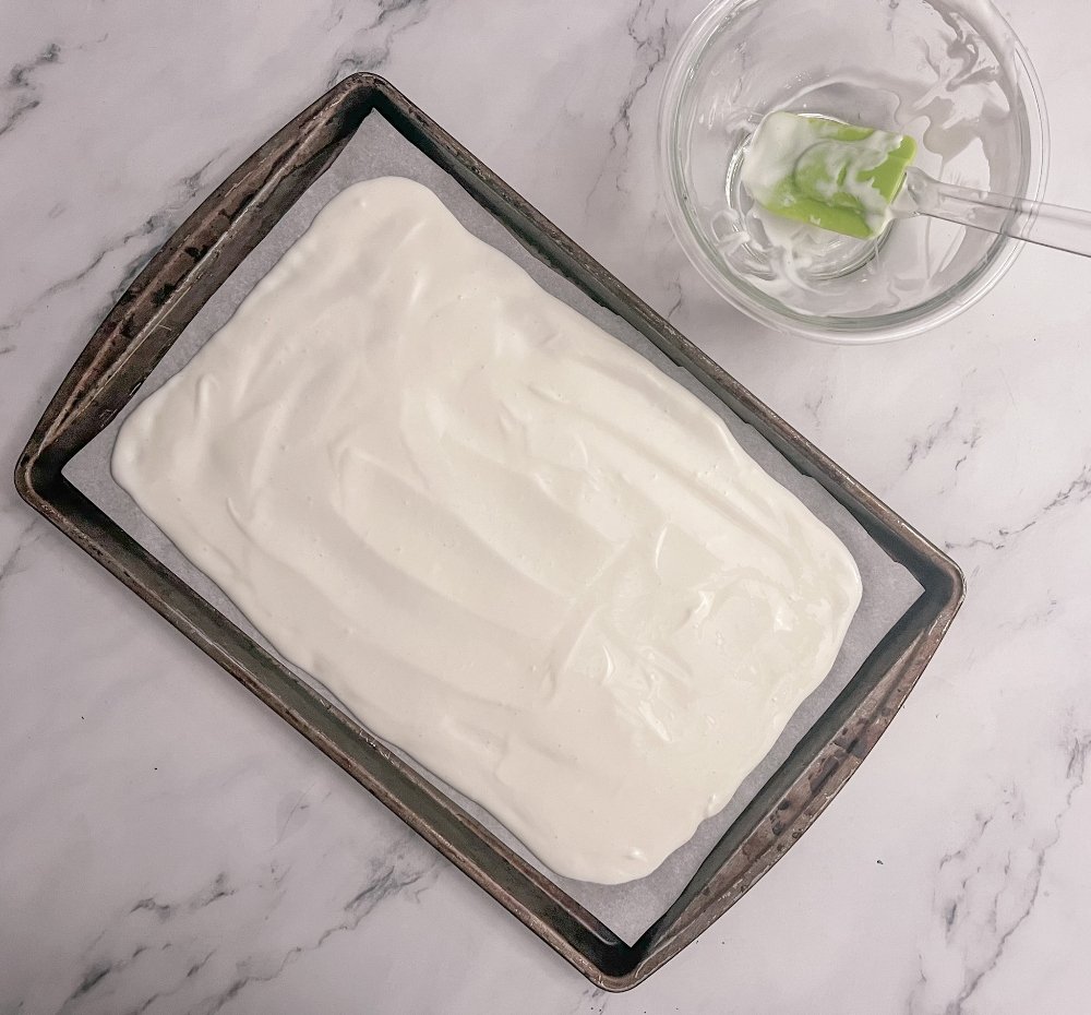 Spreading yogurt on baking sheet