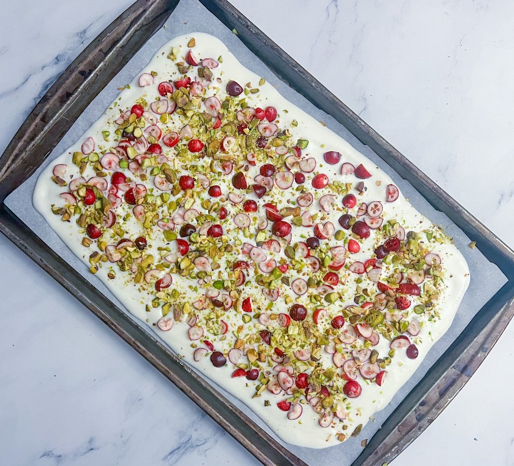 Sprinkling pistachios over yogurt