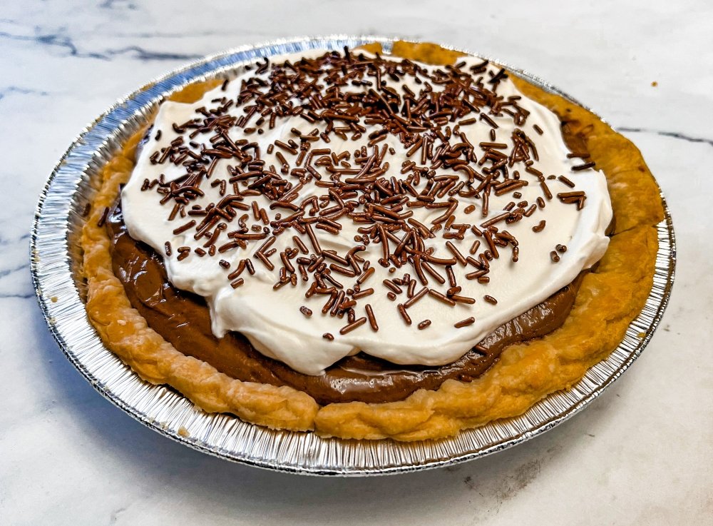 Chocolate pie topped with homemade whipped cream