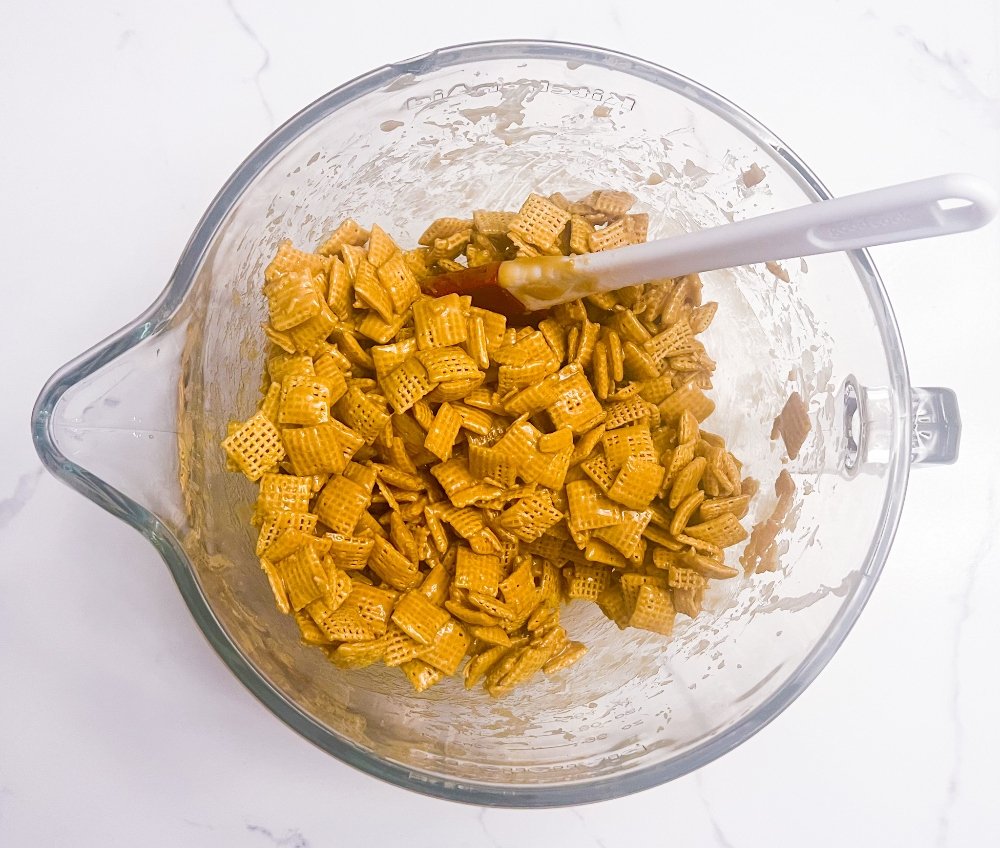 Mixing caramel with corn chex